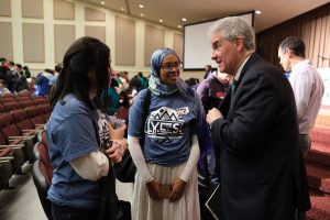 Two students chat with Secretary Shawn M. Garvin