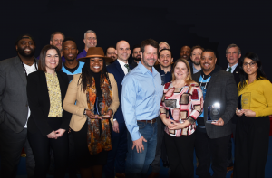 Photo of winners of the Fall 2023 EDGE grant competition against black background. Also pictured are Governor John Carney, Division Director Regina Mitchell, and Dept of State Deputy Secretary Kristopher Knight